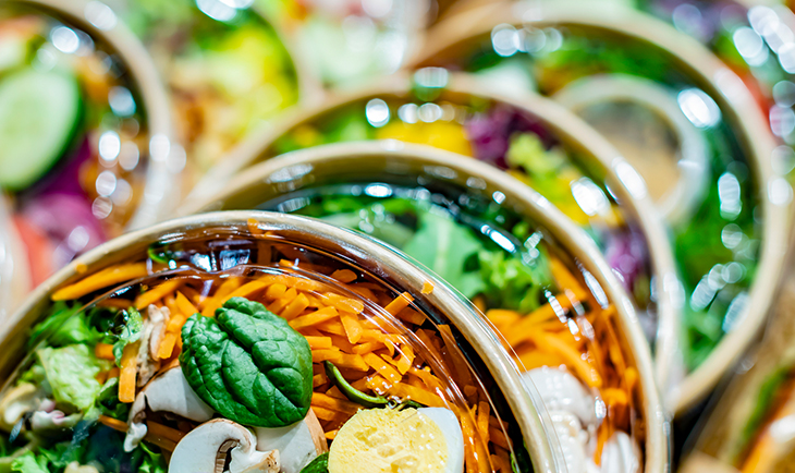 A bowl filled with a colorful mix of vegetables and various ingredients, showcasing a healthy meal option.