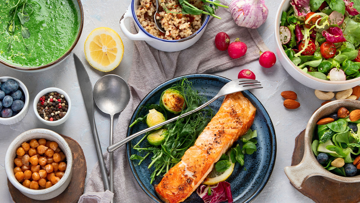 a nutritious assortment of foods including salmon salad nuts and blueberries