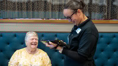Server taking an order from a senior resident.