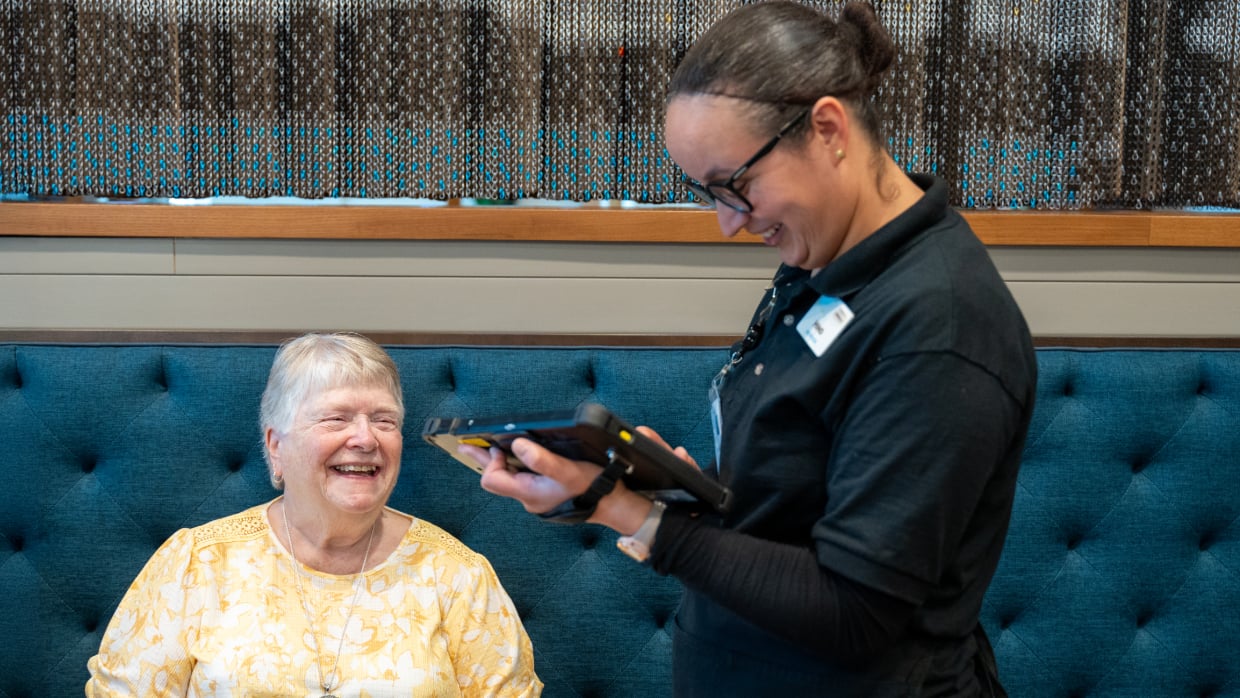 Server taking an order from a senior resident.