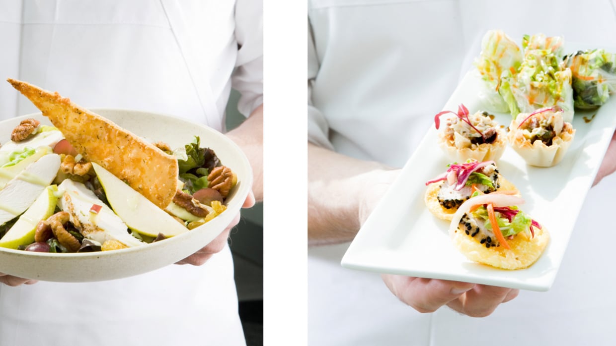 two chefs holding plate of served delicious food