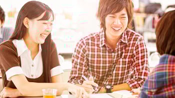  Students laughing with each other at lunch break.