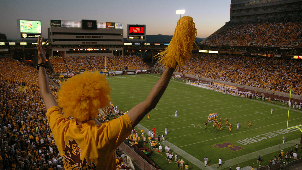 Sun Devils fan cheering on the team at the packed stadium