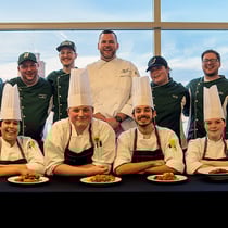 Culinary competitors smiling together with the Binghamton dining team for a group photo.