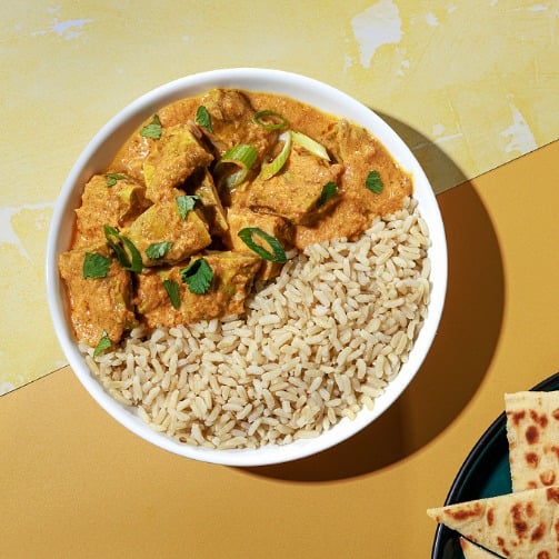 Bright Bites Kitchen Butter Chicken Bowl with brown rice and naan.