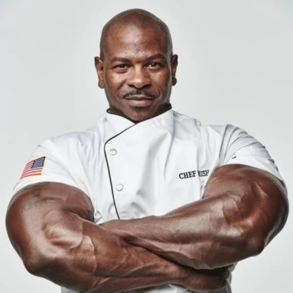A muscular chef poses confidently for a photo, showcasing his strength and physique.