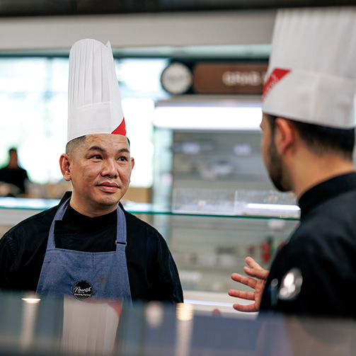 a chef talking with another one