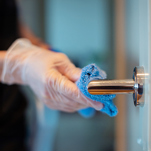 someone with gloves cleaning