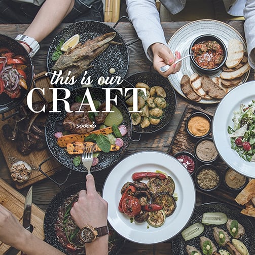 Craft magazine thumbnail showing a rustic table with plated foods like grilled vegetables, salad and more.