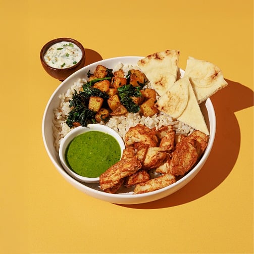 The Crave Experience: tandoori chicken bowl with rice, naan, roasted vegetables and green chutney.  