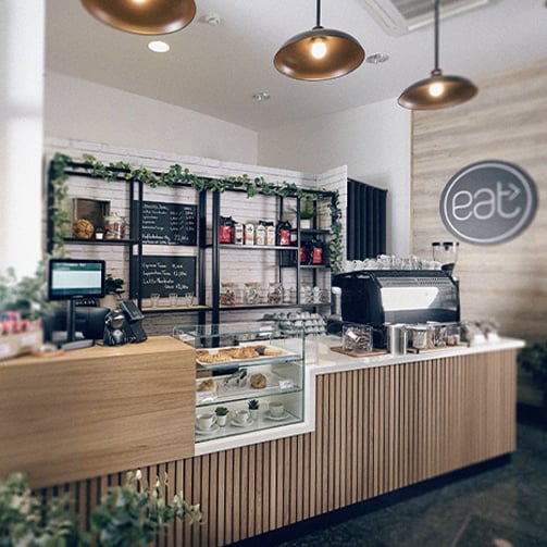 Modern interior of the eat> café featuring a bright atmosphere. 