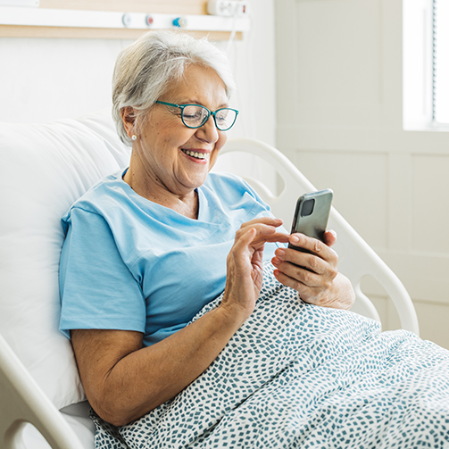 old female patient using phone at hospital