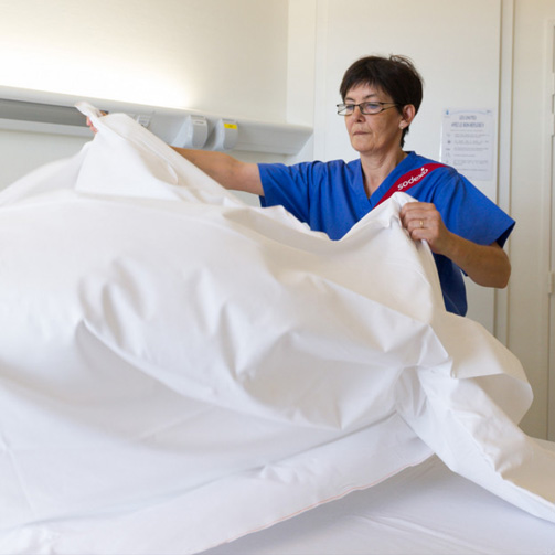 White woman making a bed