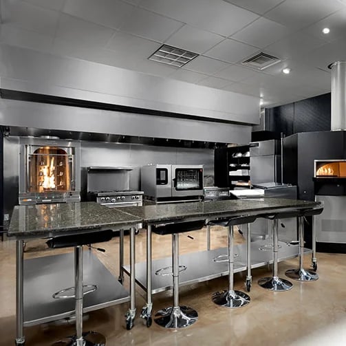 A modern kitchen featuring a countertop and a stove, showcasing a clean and organized cooking space.