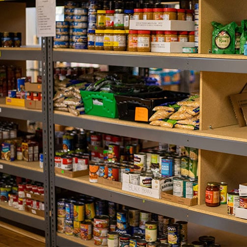 Shelves stocked with non-perishable grocery staples.