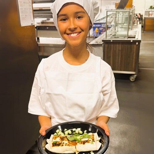 2026 Future Chefs National Champion Roselyn smiling proudly while presenting her winning recipe.