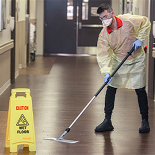 male safety cleaning floor at hospital