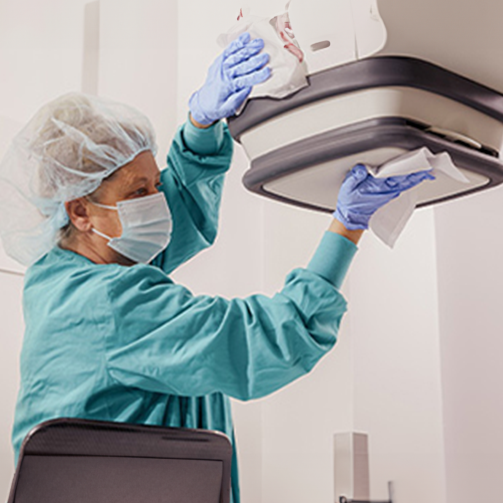 female staff cleaning clinic machines