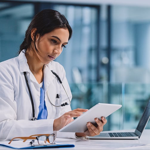 female doctor checking tablet device