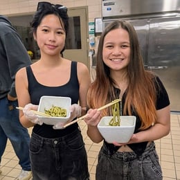 Lehigh University students showing a hand-made noodle dish from a cooking class with the Asian Studies program.