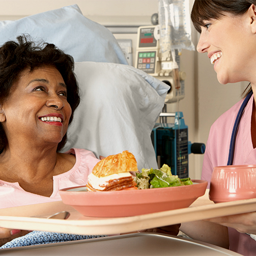 nurse serving food patient