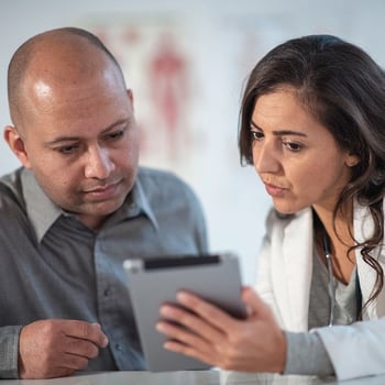 Registered dietitian and patient reviewing a nutrition plan together on a tablet. 