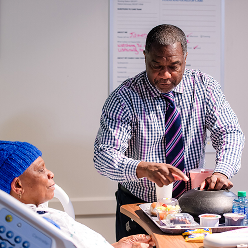 a man explaining something to a man on a hospital