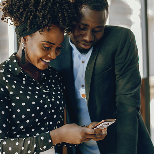 a man and a woman looking at a cellphone