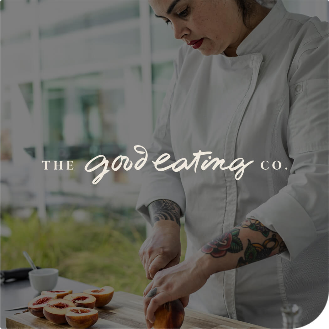 Person in a white chef coat slicing figs on a cutting board, with the text "The Good Eating Co."