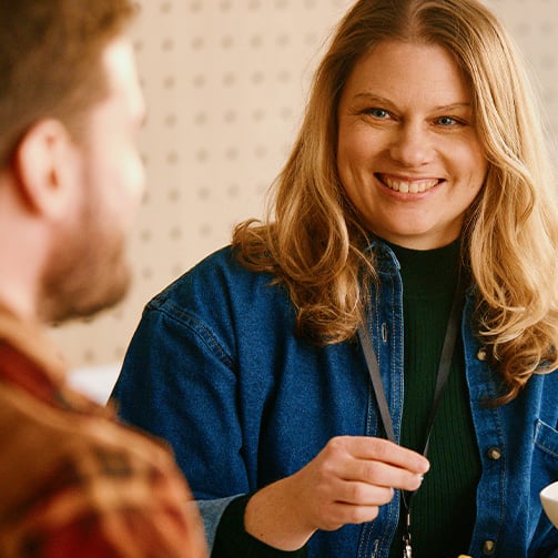 coworkers smiling while in conversation