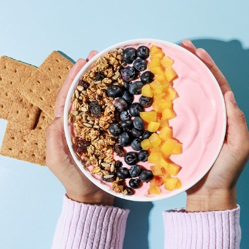 Bright Bites Kitchen Sunshine Smoothie Bowl with granola, blueberries and mango.