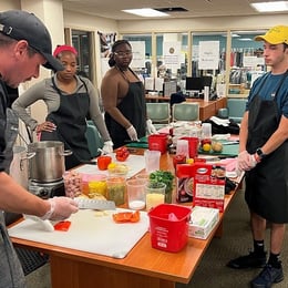 SUNY Delhi students participating in a cooking class, preparing a dish with ingredients commonly found in a food pantry.