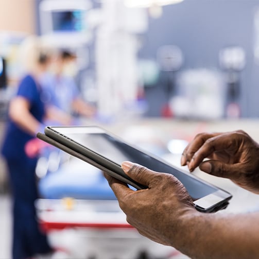 hands of person checking tablet device