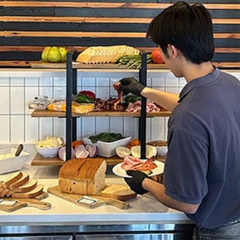 A student builds a custom sandwich at a UCook self-serve station.