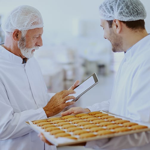 2 chefs taking notes about some food