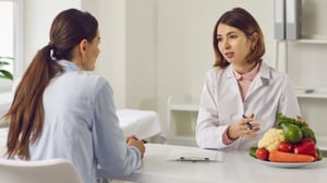 A Registered Dietitian Nutritionist (RDN) providing nutrition counseling to a patient.