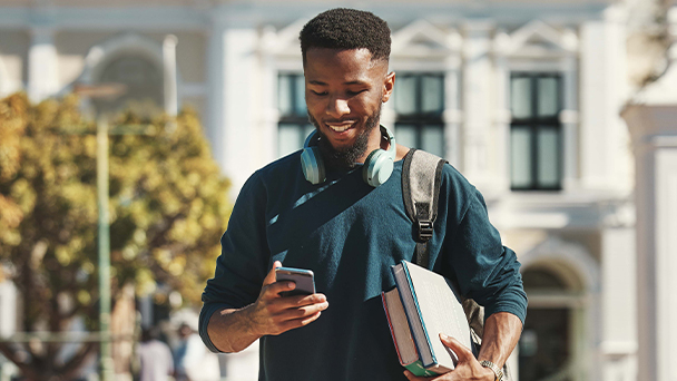 black young student man looking at cellphone