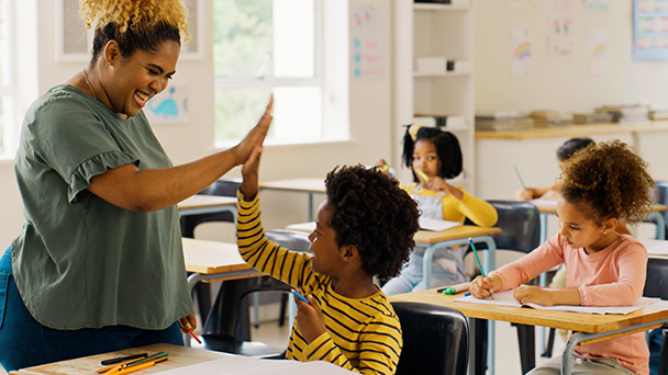 a man clapping her hand with a kid