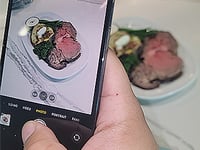 someone taking a picture of food