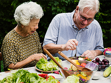 old woman and old man making a salad