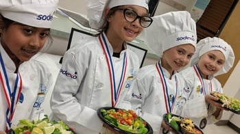 chef kids with plates of salad