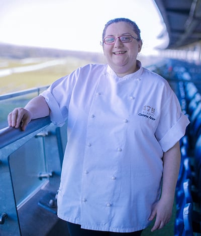 White woman with chef uniform at stadium