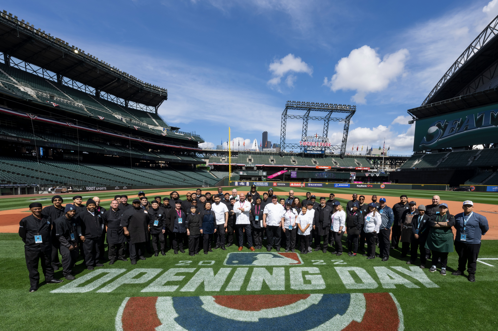 Group of people standing on baseball field