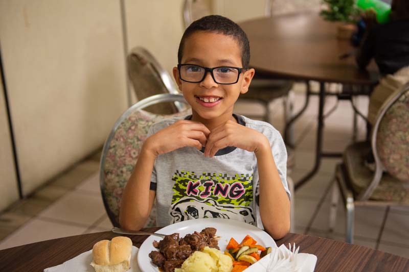 Smiling child with plate of food