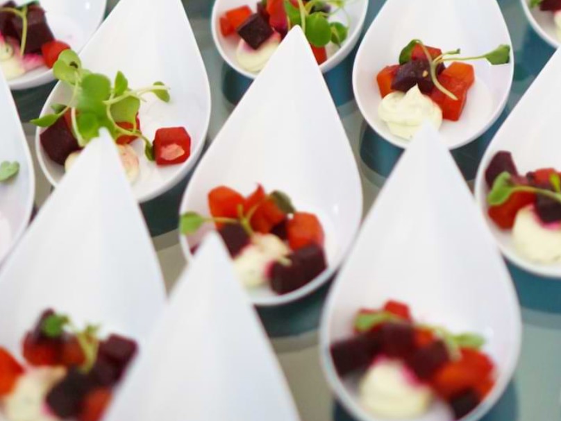 White spoons of red fruit