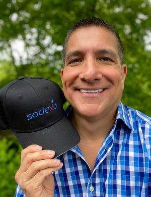 Middle man headshot holding a baseball hat