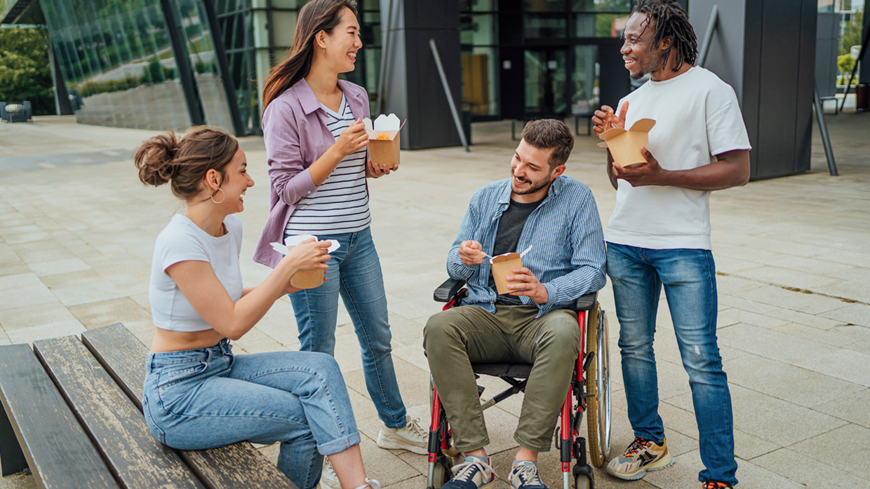 people in a street eating and smilling