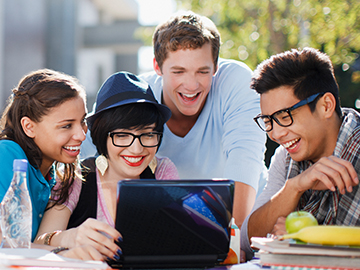 Students laughing while doing group work together