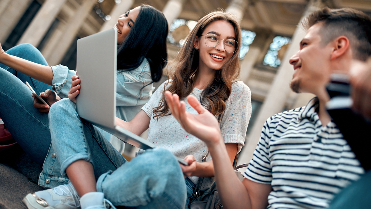 people on a meeting looking at a laptop