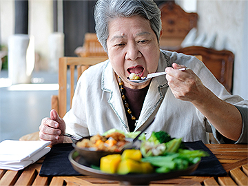 elderly woman eating healthy food